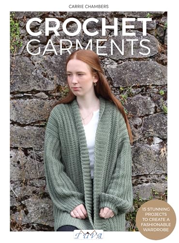 A woman with long red hair wears a green crocheted cardigan against a stone wall.
