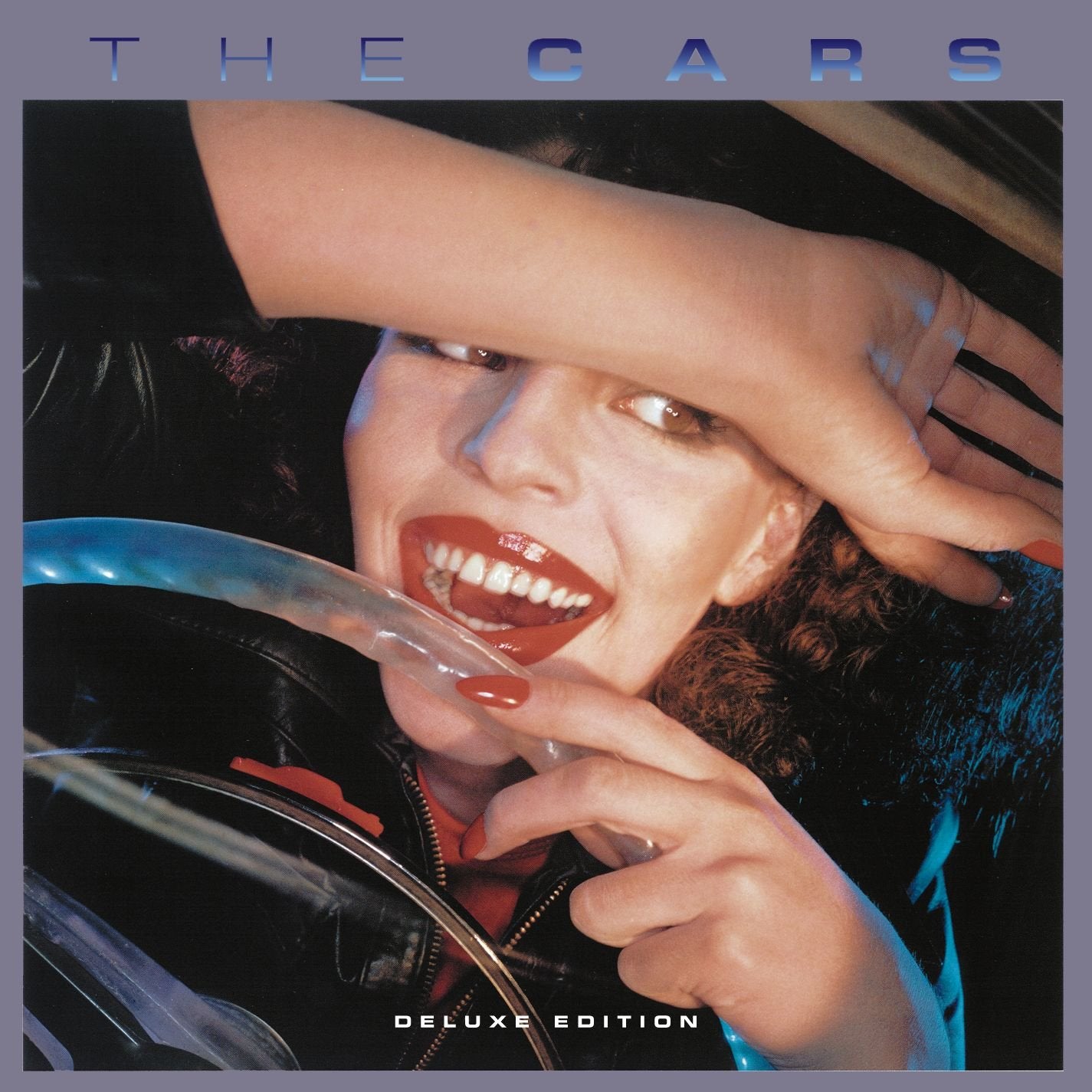 Woman in leather jacket with red lips and hand on forehead in a car.