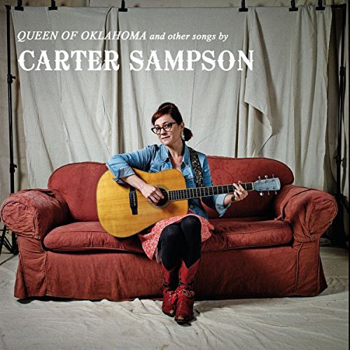 Carter Sampson sitting on a red couch holding an acoustic guitar, album cover artwork.