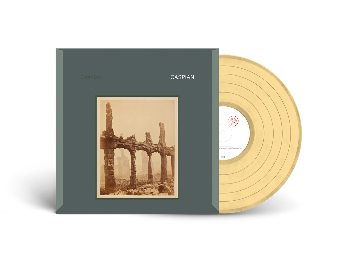 Peach vinyl record and album cover with a crumbling stone structure.