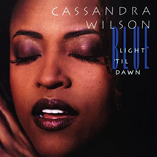 Close-up portrait of Cassandra Wilson with album title “Blue Light `Til Dawn”.