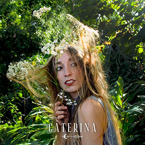 Woman with long hair surrounded by white flowers, album cover art.