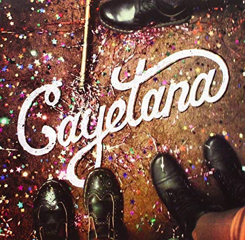 The word Cayetana written in white script over confetti-covered ground with black leather boots.