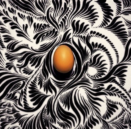 CD cover with black and white swirling patterns and a central orange oval.