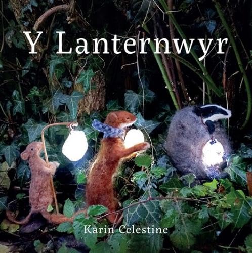 Felt mouse, weasel, and badger holding glowing lanterns in a dark, ivy-covered forest setting.