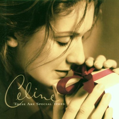 Celine Dion album cover, close-up of her holding a red ribboned gift.