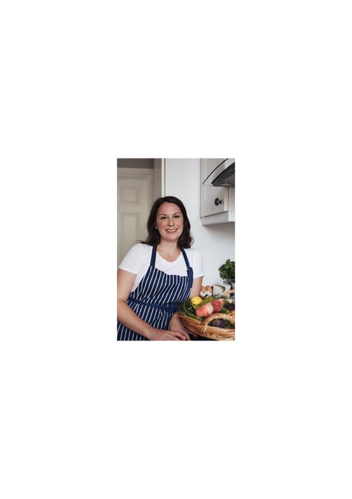 A woman in a striped apron holds a basket of fresh vegetables in a kitchen.