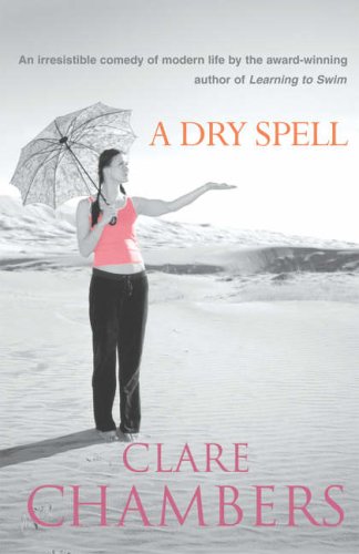 A woman in a pink top holds an umbrella on a sandy beach.