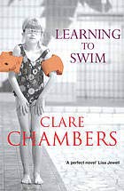Book cover with red inflatable rings and title "Learning To Swim".