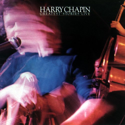 Blurry image of a man playing guitar and singing into a microphone on stage.