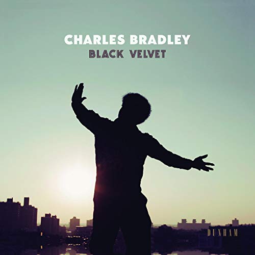 SilhouetteCLSsilhouette of a man withHH with arms outstretched against a city skyline sunset.