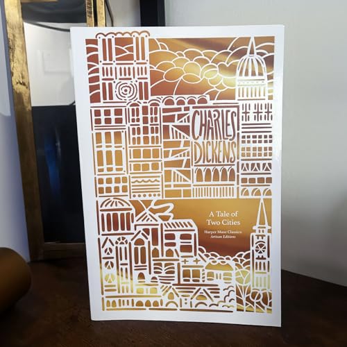 “A Tale of Two Cities” book cover with intricate white cityscape design.
