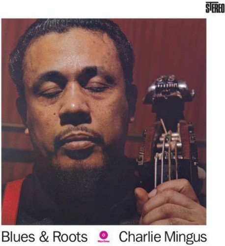 Charles Mingus portrait with bass guitar on the album cover “Blues & Roots.”