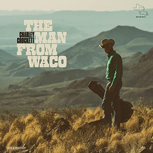Charley Crockett album cover featuring a man with a guitar in a landscape.