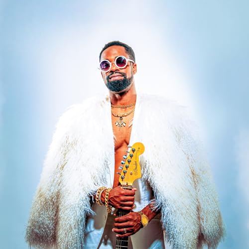 Man with beard, sunglasses, and fur coat holding a yellow electric guitar.