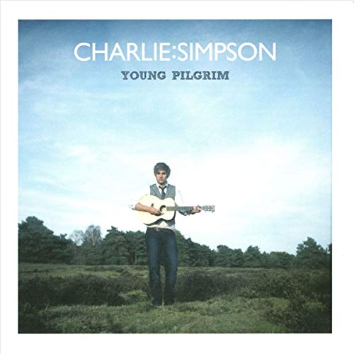 CD cover: Charlie Simpson with guitar in a grassy field.
