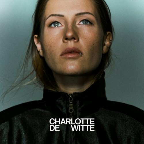 Close-up portrait of Charlotte De Witte, a DJ, with piercing blue eyes.