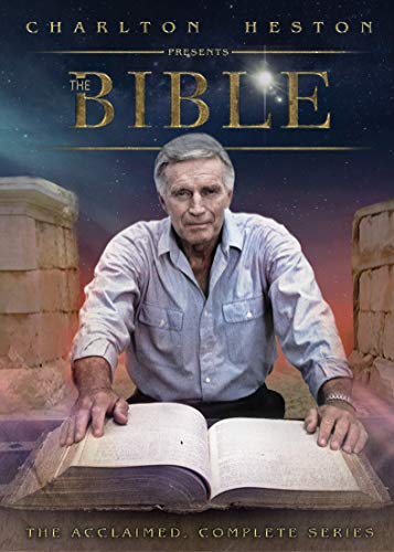 Charlton Heston sits behind a large open book against a starry sky background.