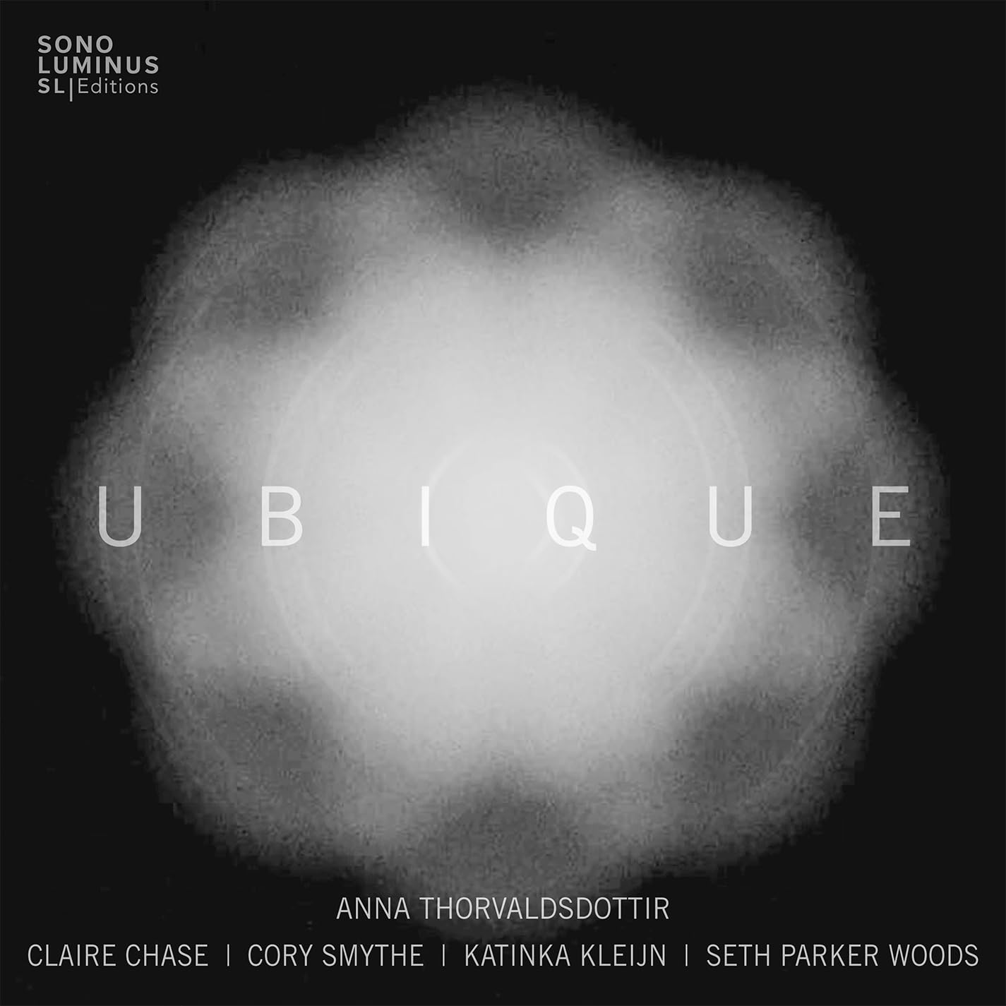 CD cover: dark background with bright central orb and text "UBIQUE".