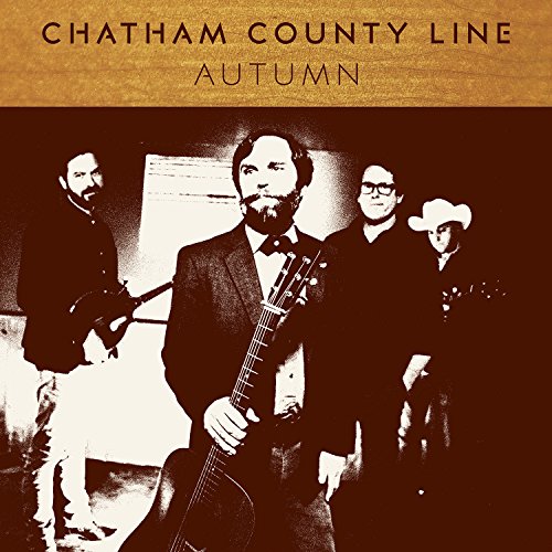 "Album cover featuring four men, one holding a guitar, in formal attire."
