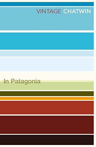 The image depicts a book cover with horizontal stripes in various colours, including blue, green, and brown. Alt text: Book cover with multicoloured horizontal stripes and title "In Patagonia" and "VINTAGE CHATWIN".