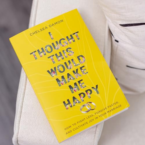 Yellow book cover with floral text and two wedding rings.