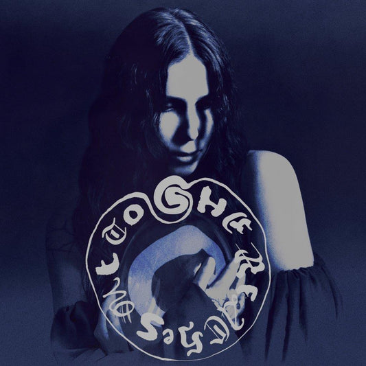 Cyanotone portrait of Chelsea Wolfe with circular text overlay.