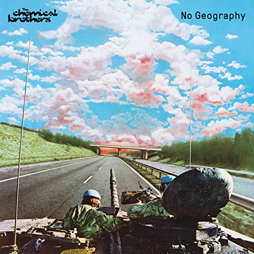 Soldiers in a tank driving down a highway under a bright, cloudy blue sky.