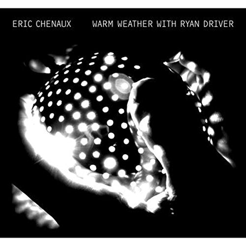 Album cover with white text on black background, featuring a glowing, polka-dotted spherical object.