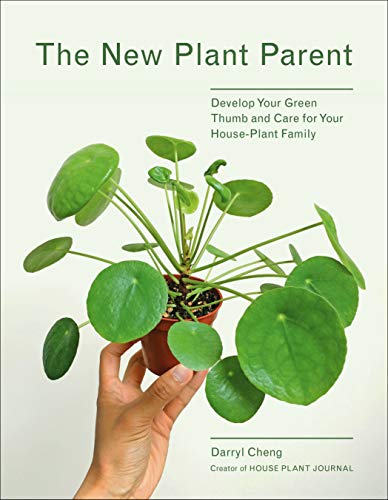 Book cover featuring a hand holding a potted Pilea peperomioides plant with round leaves.