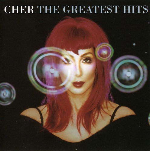 Cher album cover featuring the singer with red hair and colorful rings.