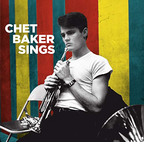 Chet Baker holding a trumpet against a background of colorful vertical stripes.