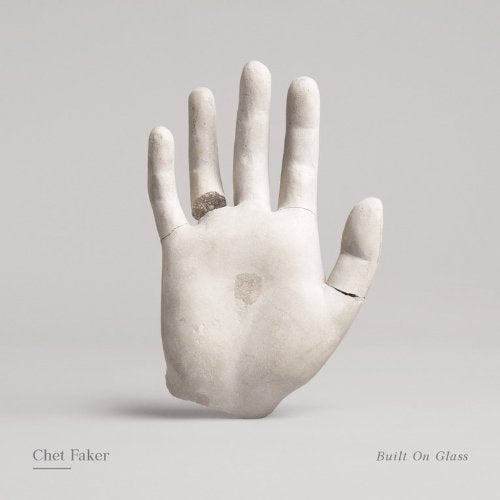 Chet Faker “Built On Glass” album cover: a pale, fractured hand.