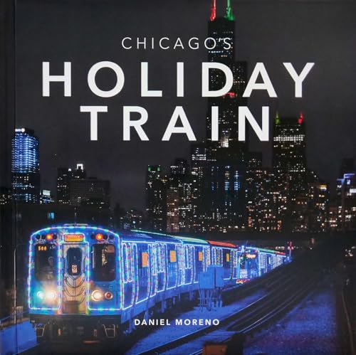 Chicago Holiday Train illuminated with blue lights against a city skyline.