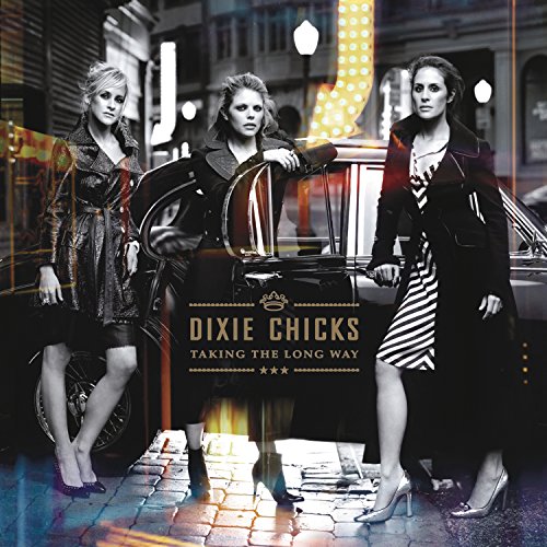 "Album cover featuring three women standing by a vintage car at night."