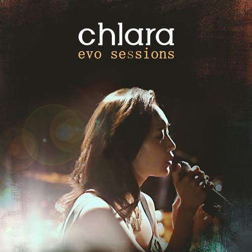 "Album cover featuring a woman singing into a microphone with 'chlara evo sessions' text."