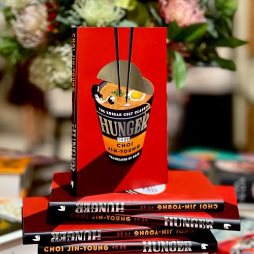 Red book cover with ramen illustration, stacked with multiple copies.