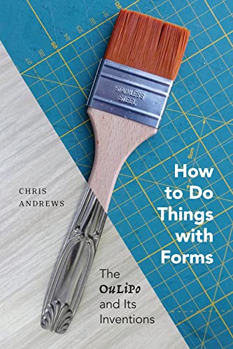 Book cover with paintbrush and tongs on a blue cutting mat.