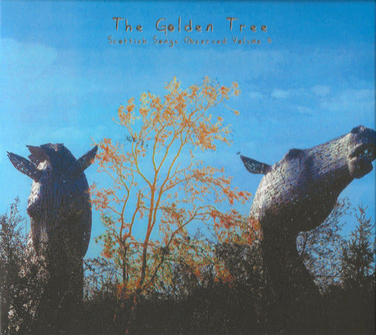 CD cover with sculpted whales and a small tree against a blue sky.