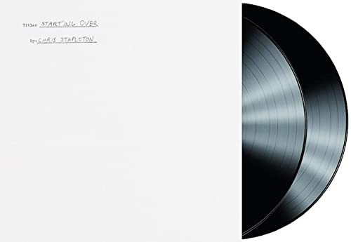 White album cover with handwritten text and a black vinyl record partially visible.