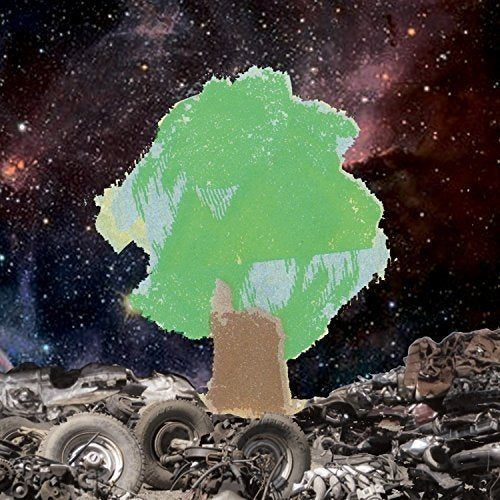 A green tree silhouette on a pile of car parts against a starry space background.