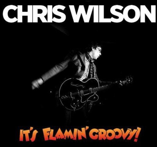 "Album cover with black background, man playing guitar, and bold text 'CHRIS WILSON' and 'IT'S FLAMIN' GROOVY!'".