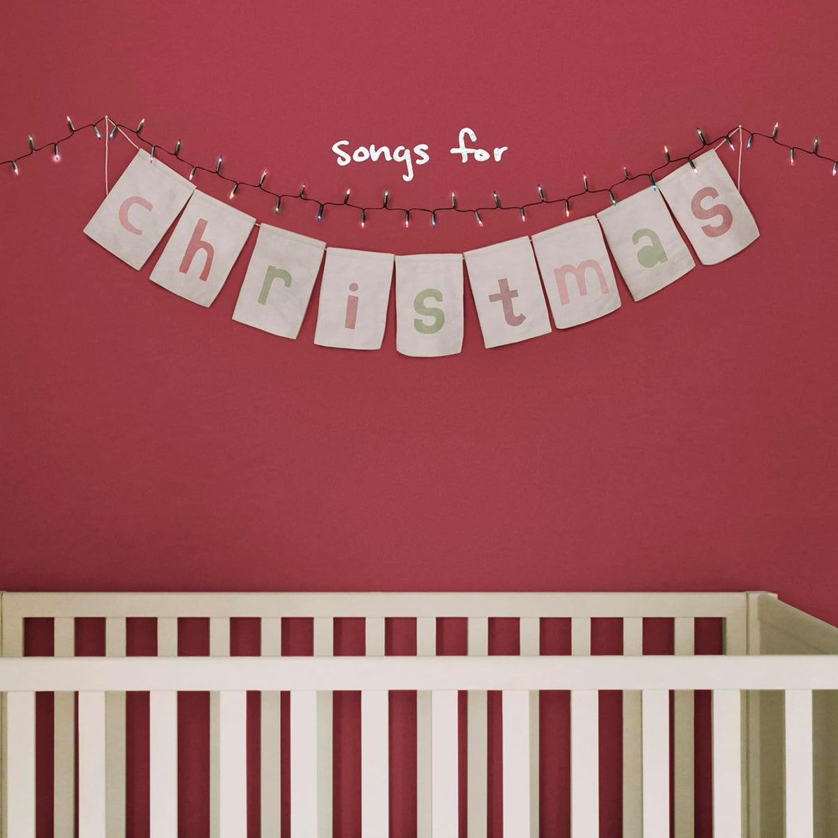 Album cover for “Songs for Christmas” with a banner and crib.