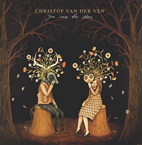 Album cover with man and woman with floral heads sitting on tree stumps.