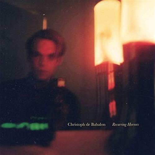 The album cover for "Christoph De Babylon - Recurring Horrors" features a man in a dark room.