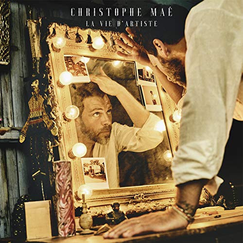 Christophe Maé album cover featuring a man looking in a mirror with lights.