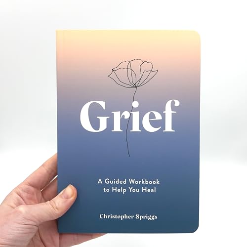 Book cover with title "Grief" and a floral illustration, held in a hand.