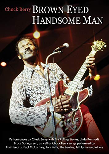 Chuck Berry playing an electric guitar on stage, with concert lighting in the background.