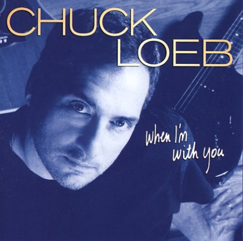"Blue-toned album cover with Chuck Loeb holding a guitar, his name and album title."