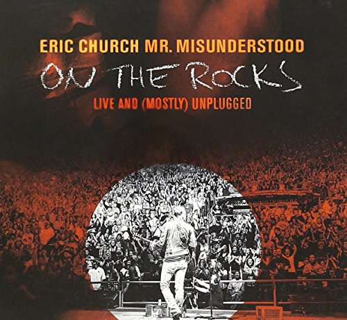 Eric Church album cover: musician with crowd, dark and smoky background.